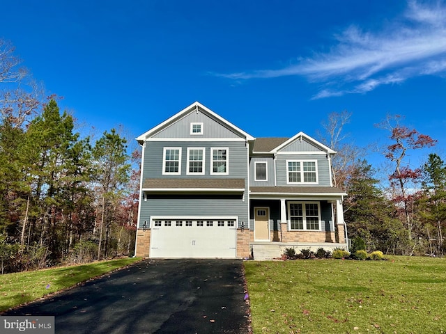 view of front of house with a front yard, a porch, and a garage