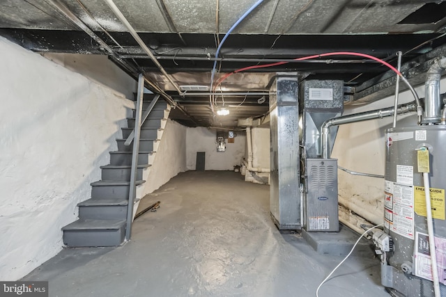 basement featuring heating unit and water heater