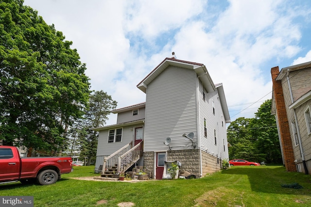 rear view of house with a yard