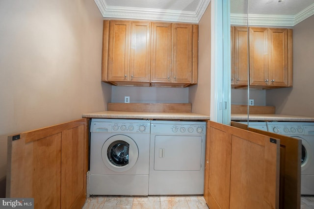 washroom with cabinets, independent washer and dryer, and ornamental molding