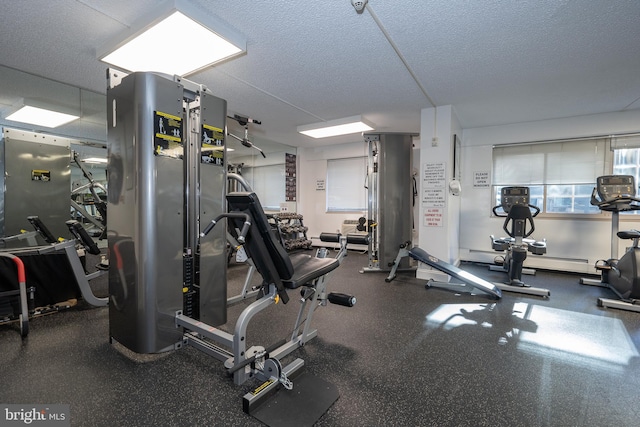 workout area featuring a textured ceiling