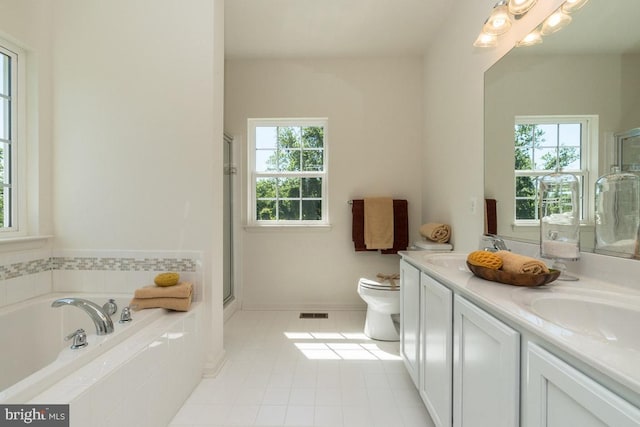 full bathroom with toilet, vanity, tile patterned floors, and a wealth of natural light