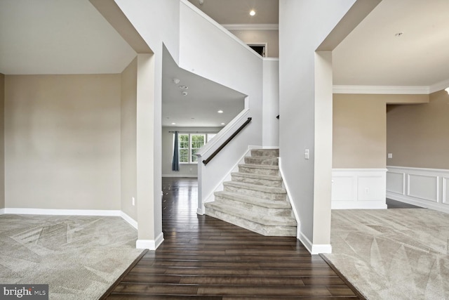 stairway with crown molding and hardwood / wood-style flooring