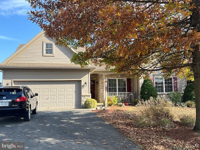 obstructed view of property featuring a porch and a garage