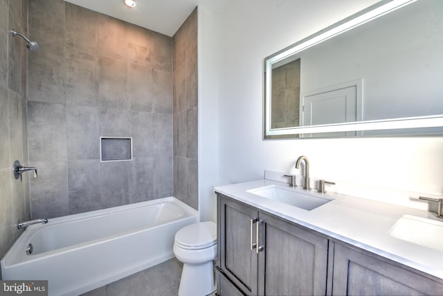 full bathroom with toilet, tiled shower / bath combo, tile patterned floors, and vanity