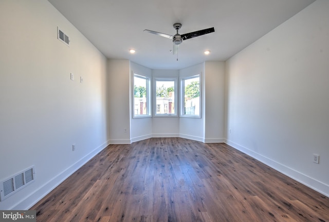 empty room featuring ceiling fan and dark hardwood / wood-style floors