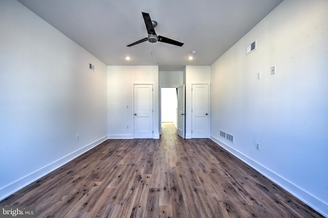 unfurnished bedroom with ceiling fan and dark hardwood / wood-style flooring