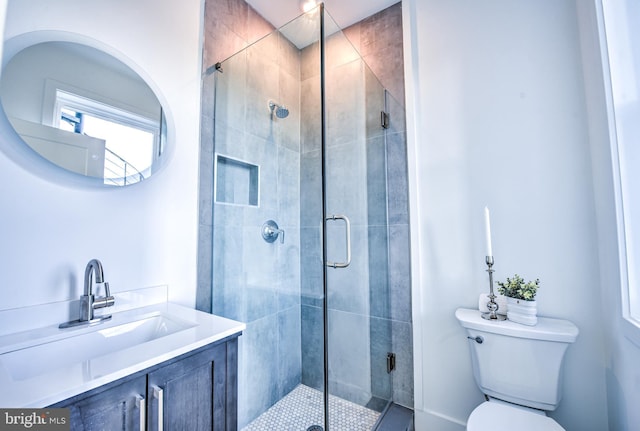 bathroom featuring walk in shower, vanity, and toilet