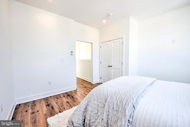 bedroom featuring light wood-type flooring and a closet