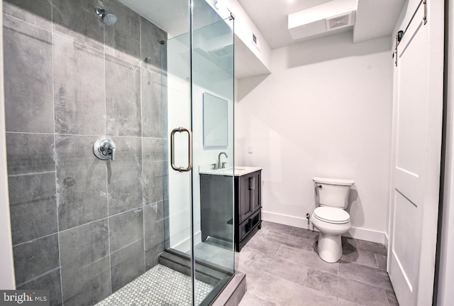 bathroom with toilet, a shower with shower door, and vanity