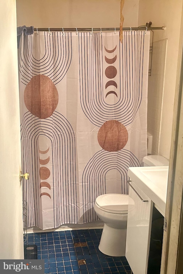 bathroom with toilet and tile patterned flooring