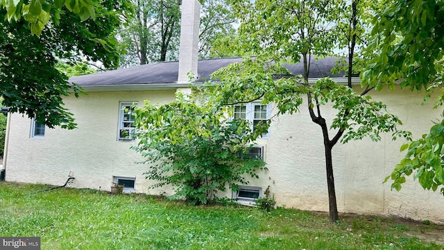 view of property exterior featuring a yard