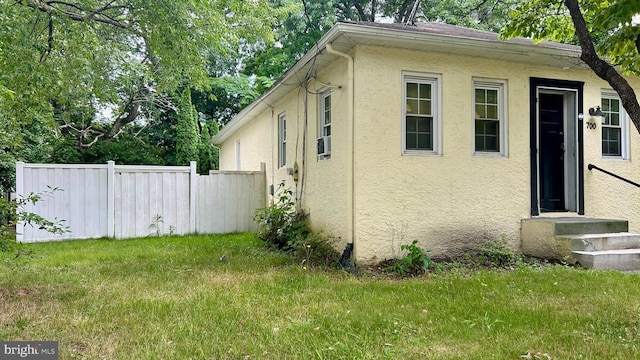 view of side of home featuring a lawn