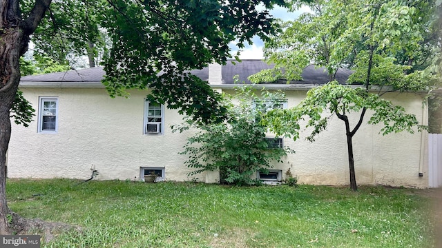 view of property exterior featuring a lawn