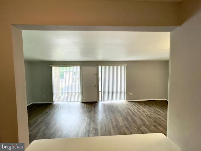 spare room with dark hardwood / wood-style flooring