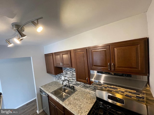 kitchen with backsplash, dark hardwood / wood-style floors, sink, and appliances with stainless steel finishes