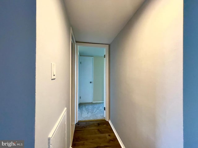 corridor featuring dark hardwood / wood-style floors