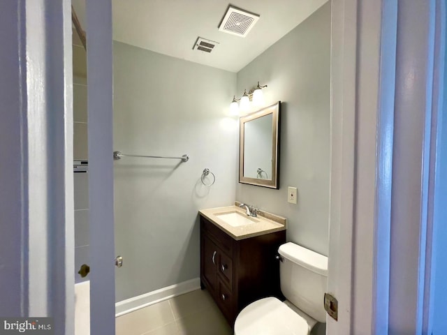 bathroom featuring tile patterned floors, vanity, and toilet