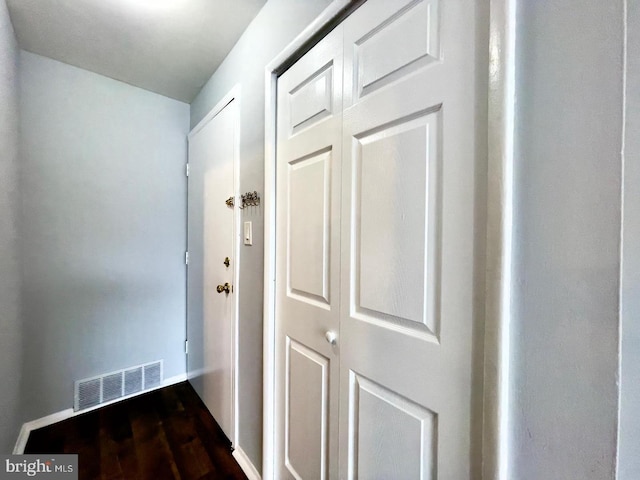 corridor featuring dark hardwood / wood-style flooring