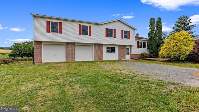 view of front of property with a front yard and a garage