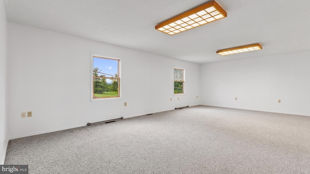 empty room with plenty of natural light and carpet floors