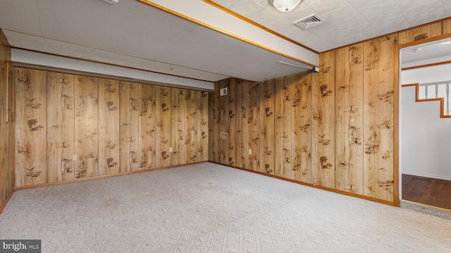 basement with wooden walls and carpet