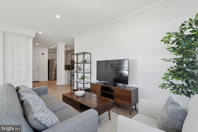 living room featuring light hardwood / wood-style floors and ornamental molding