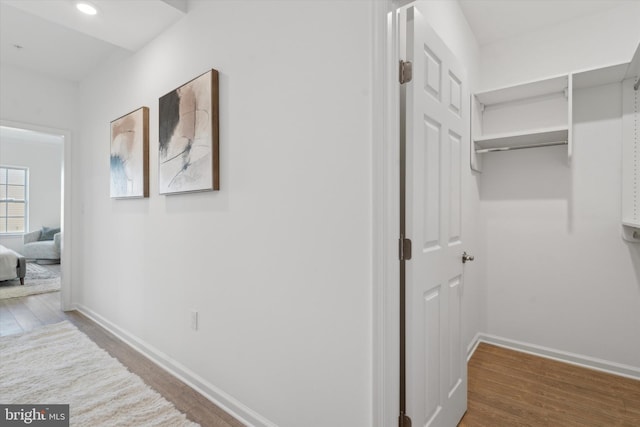 hallway with hardwood / wood-style floors