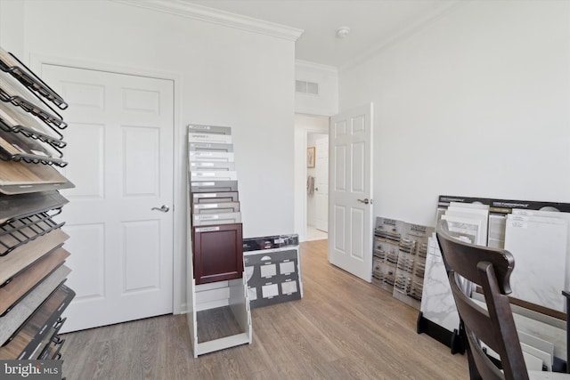 office featuring light hardwood / wood-style floors and ornamental molding