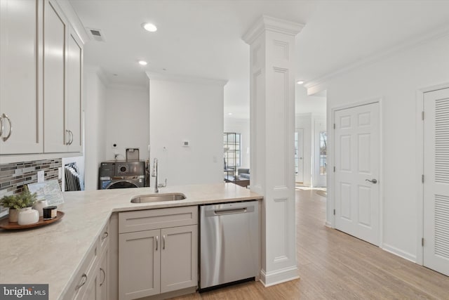 kitchen featuring light wood-type flooring, ornate columns, crown molding, sink, and dishwasher