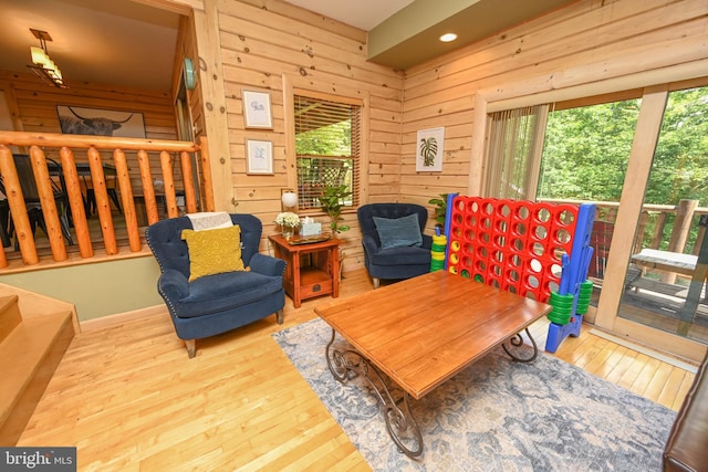 sitting room featuring light hardwood / wood-style flooring and wood walls