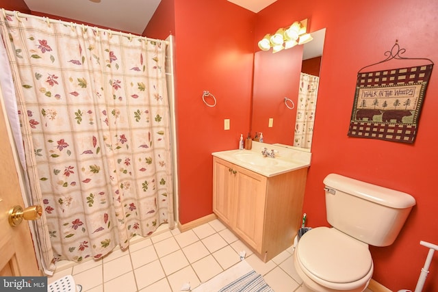 bathroom with tile patterned floors, curtained shower, vanity, and toilet