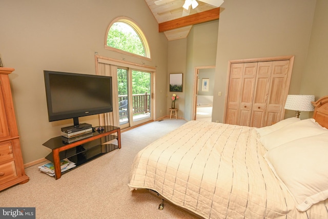 bedroom with high vaulted ceiling, carpet floors, and access to outside