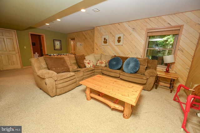 living room with carpet and wood walls