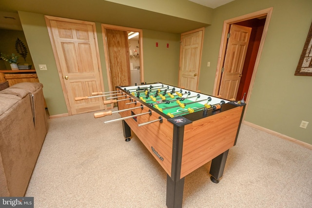 playroom with washer / dryer and light colored carpet