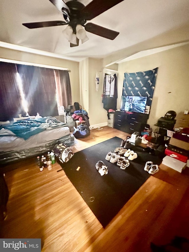 interior space with ceiling fan and wood-type flooring