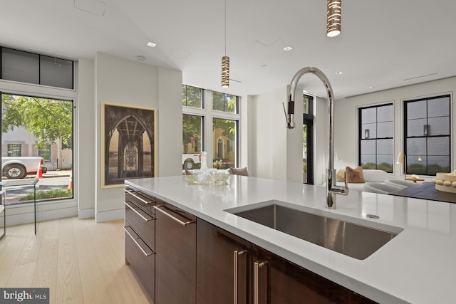 3255 Prospect St NW One, Unit One, Washington, DC 20007 - kitchen with light countertops, open floor plan, light wood-style floors, recessed lighting, and dark brown cabinetry