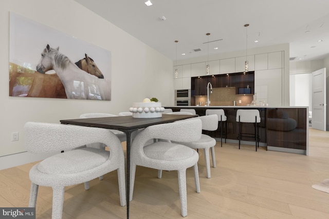 3255 Prospect St NW One, Unit One, Washington, DC 20007 - dining area featuring recessed lighting, light wood-type flooring, and bar with sink