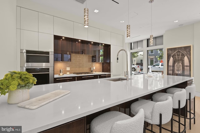 3255 Prospect St NW One, Unit One, Washington, DC 20007 - kitchen featuring a sink, stainless steel appliances, modern cabinets, a kitchen bar, and recessed lighting