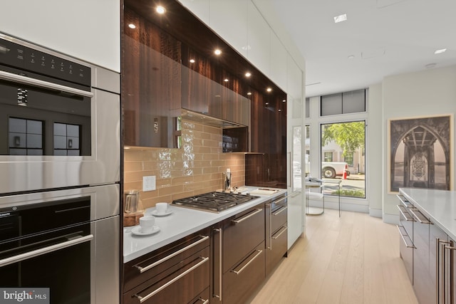 3255 Prospect St NW One, Unit One, Washington, DC 20007 - kitchen with modern cabinets, light countertops, stainless steel appliances, and backsplash