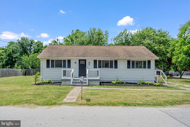 single story home featuring a front lawn