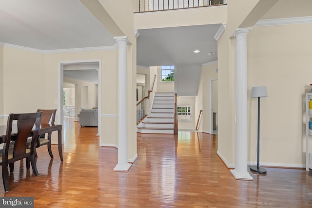 entryway with crown molding and light hardwood / wood-style flooring