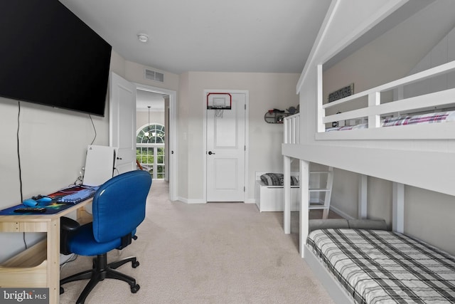 carpeted bedroom with a chandelier