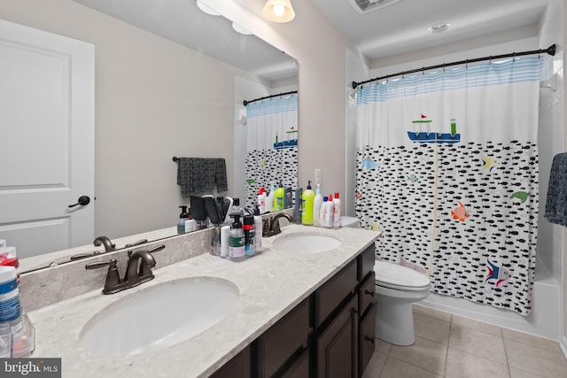 full bathroom featuring tile patterned flooring, vanity, toilet, and shower / tub combo