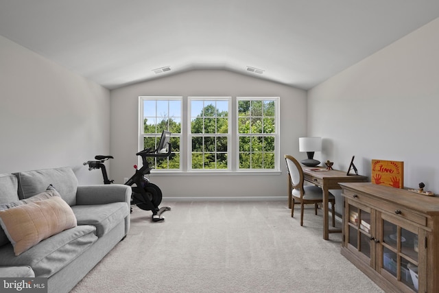 carpeted home office featuring vaulted ceiling