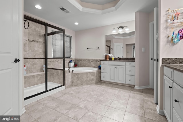 bathroom with plus walk in shower, vanity, a raised ceiling, and ornamental molding