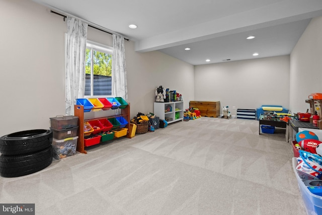 recreation room featuring carpet flooring and beam ceiling