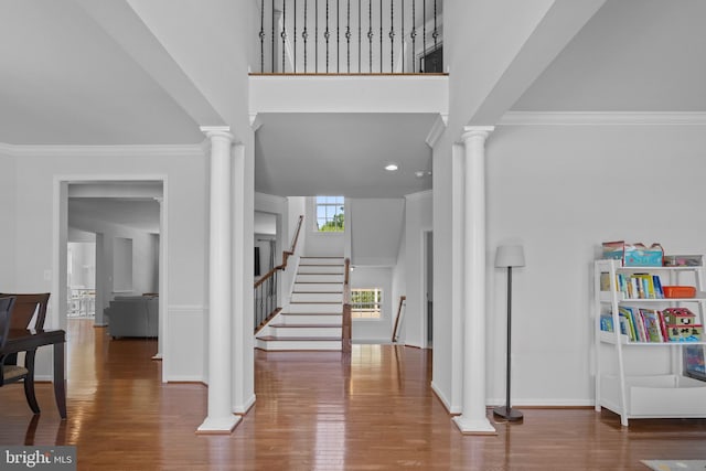 foyer entrance with hardwood / wood-style floors and crown molding