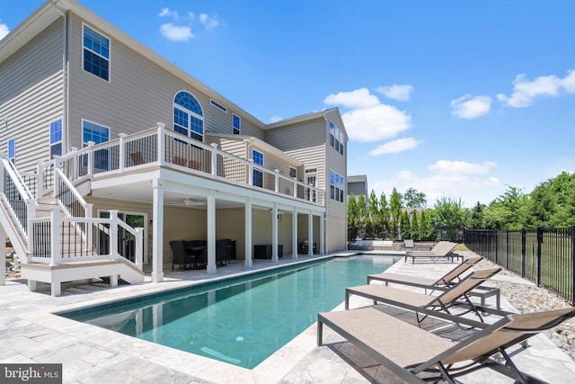 view of pool with ceiling fan and a patio