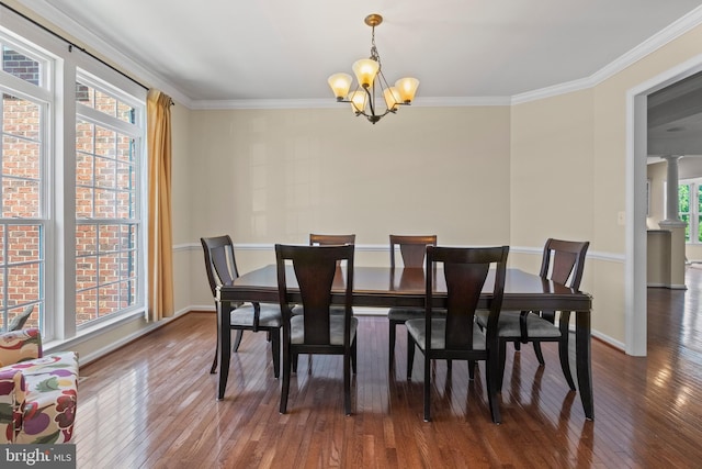 dining room with plenty of natural light, dark wood-type flooring, and a notable chandelier